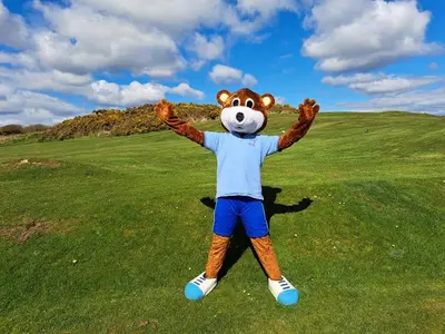 a person in a bear costume standing on a field at Burrowhead Holiday Village in Isle of Whithorn