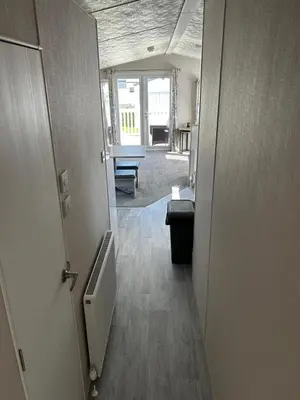 an open door to a room with a hallway at Burrowhead Holiday Village in Isle of Whithorn