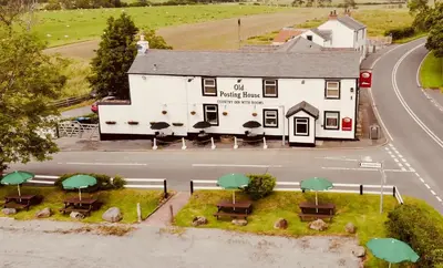 a model of a building with tables and umbrellas at Old Posting House in Cockermouth