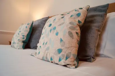 two pillows sitting on top of a bed at Old Posting House in Cockermouth