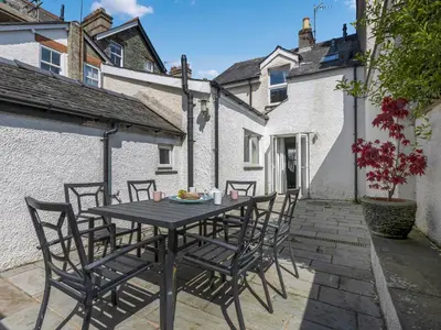 a table and chairs on the patio of a house at Tommy's Cottage in Keswick
