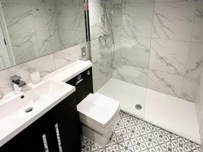 a bathroom with a sink and a toilet and a shower at Breckenridge in Keswick