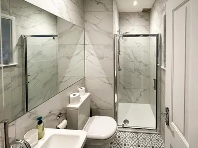 a bathroom with a shower and a toilet and a sink at Breckenridge in Keswick