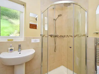 a bathroom with a shower and a sink at Holly Bank in Bassenthwaite
