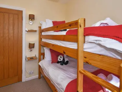a bedroom with two bunk beds with a stuffed animal at Holly Bank in Bassenthwaite