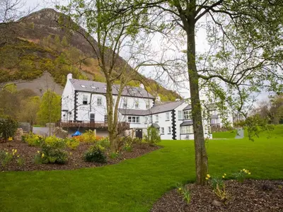 a large white house with trees in a yard at Carrigbaun in Braithwaite