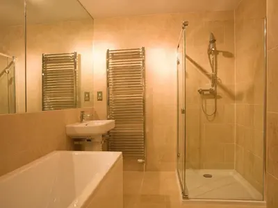 a bathroom with a tub and a sink and a shower at Carrigbaun in Braithwaite