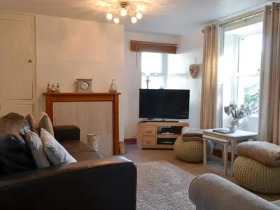 a living room with a couch and a flat screen tv at Fairholme in Braithwaite