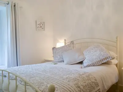 a bedroom with a white bed with pillows on it at Fairholme in Braithwaite