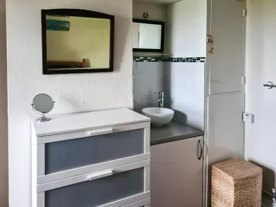 a bathroom with a sink and a mirror at Cosy Cottage in Allonby