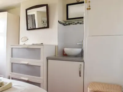 a small bathroom with a sink and a mirror at Cosy Cottage in Allonby