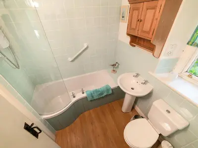 a bathroom with a tub and a toilet and a sink at Corner House in Lorton