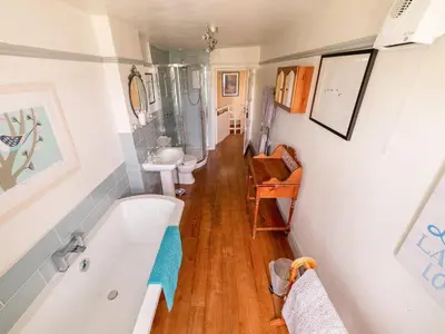 a bathroom with a tub and a sink at Corner House in Lorton