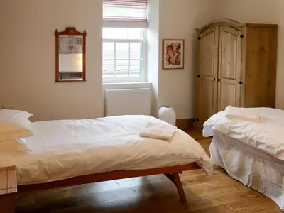 a bedroom with two beds and a window at The Moat House in Annan