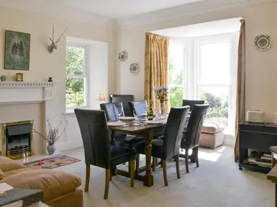 a living room with a dining room table and chairs at Fairview in Rockcliffe