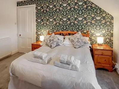 a bedroom with a bed with two towels on it at Culquhasen in Gillespie