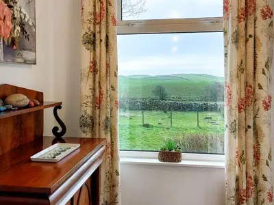 a window with a view of a green field at Culquhasen in Gillespie