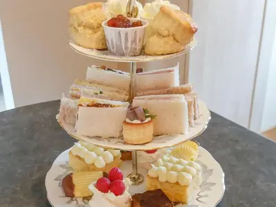 a three tiered display of different types of desserts at Riverside Cottage in Boreland