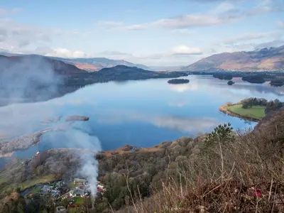 an aerial view of a lake in the mountains at Aden Barn in Allonby