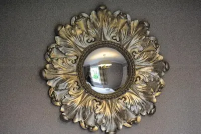 a gold mirror hanging on a wall at The Huntingdon in Dumfries