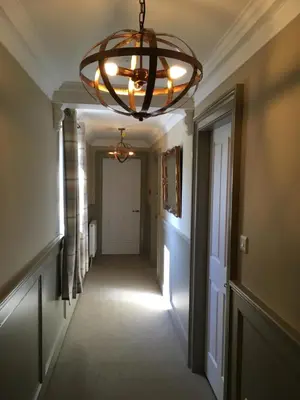 a hallway with a large chandelier in a house at The Huntingdon in Dumfries