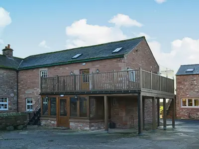 a large brick building with a balcony on top of it at Saddleback Penthouse in Penrith
