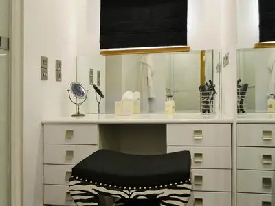 a room with a desk with a chair and a mirror at Saddleback Penthouse in Penrith