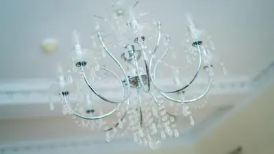 a white chandelier hanging from a ceiling at Braidmead House in Irvine