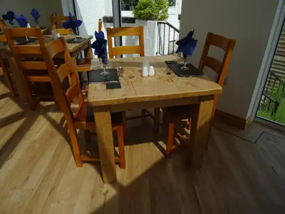 a wooden table with chairs and a dining room at Lutwidge Arms in Holmrook