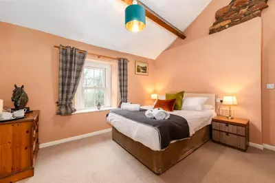a bedroom with a bed and a window at The Red Admiral Gosforth CA20 1BP in Seascale