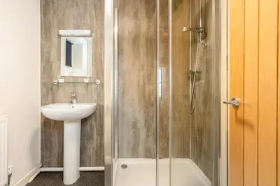 a bathroom with a sink and a shower at The Red Admiral Gosforth CA20 1BP in Seascale