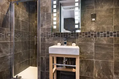 a bathroom with a sink and a mirror at The Traveller's Rest in Grasmere