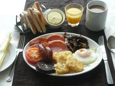 a plate of breakfast food on a table with eggs and toast at Bailey Ground Hotel in Seascale