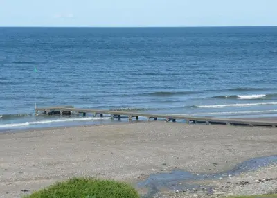 a pier on the beach near the ocean at Bailey Ground Hotel in Seascale