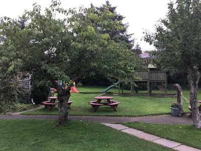 a picnic table in a park with a kite at The Mariner Hotel in Kippford