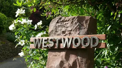 a sign that says westwood on a rock at Westwood - The B&B with a view in Cockermouth