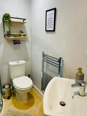 a bathroom with a toilet and a sink at Rivendell Guest House in Keswick