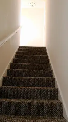 a stairway with a staircase leading up to a window at Dumfries Central apartment in Dumfries
