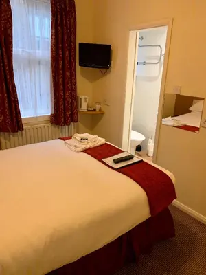 a hotel room with a bed and a window at The Island & Fairfield in Douglas