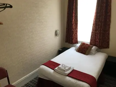 a hotel room with a bed with towels on it at The Island & Fairfield in Douglas