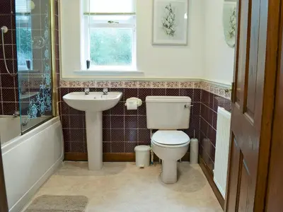 a bathroom with a toilet and a sink at Latrigg View in Keswick