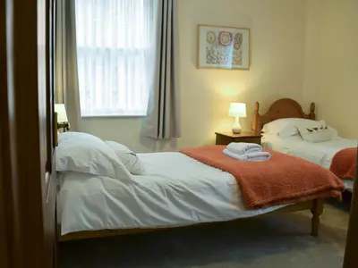 a bedroom with two beds with towels on them at Latrigg View in Keswick