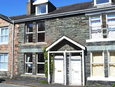 a brick house with white doors and windows at Saddleback in Keswick
