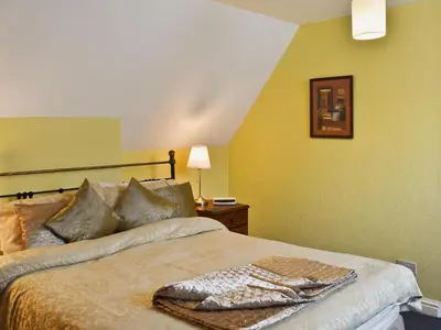 a bedroom with a bed with a blanket on it at Blencathra House in Keswick