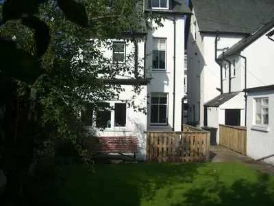 a white house with a fence in front of it at Blencathra House in Keswick