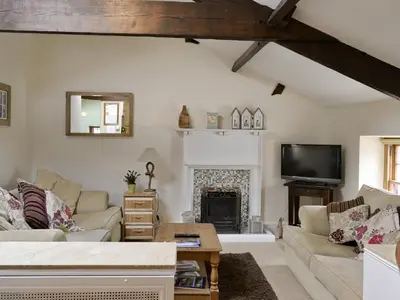 a living room with a couch and a fireplace at Lund Cottage Was Gabriel's Cottage in Keswick