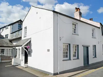 a white building on the side of a street at Lund Cottage Was Gabriel's Cottage in Keswick