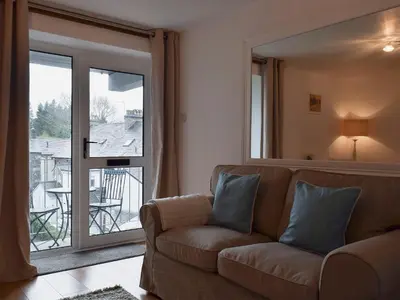 a living room with a couch and a large window at Royal Views in Keswick