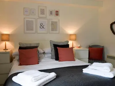 a bedroom with a bed with two towels on it at Royal Views in Keswick
