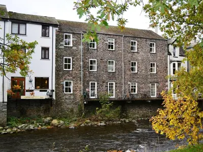 a large brick building next to a river at 2 Greta Side Court in Keswick